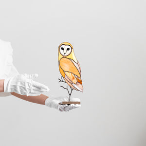 Barn owl stained glass table sculpture with warm amber tones on display