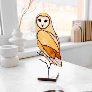 Barn owl stained glass table sculpture with warm amber tones on display