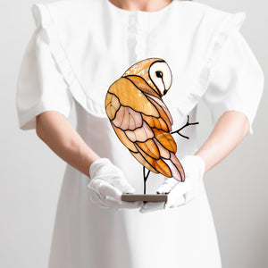 Barn owl stained glass table sculpture with warm amber tones on display