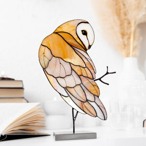 Barn owl stained glass table sculpture with warm amber tones on display