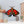 Stained glass moth wall decor with red poppy flowers and dark iridescent wings
