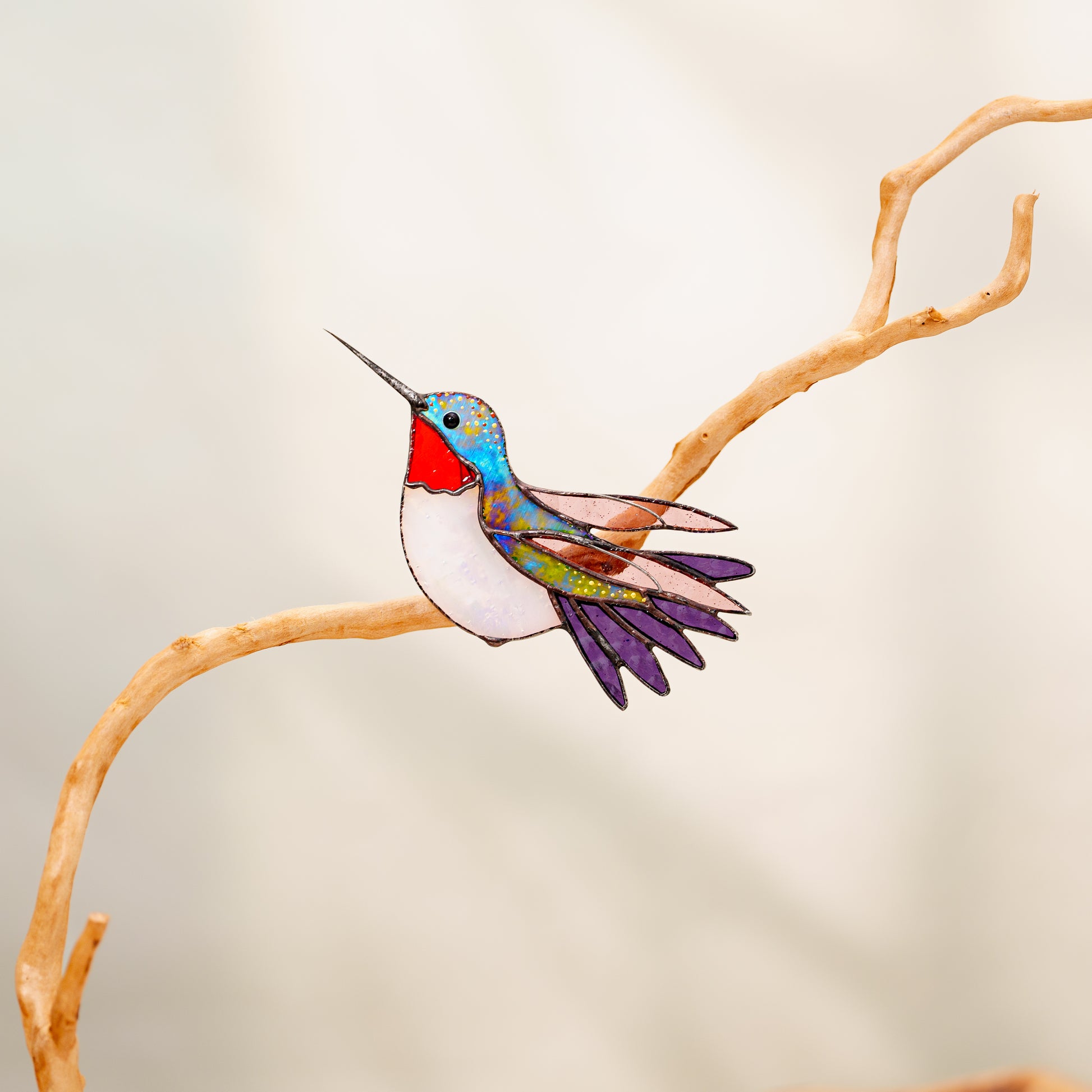 Ruby-throated hummingbird stained glass clip decor attached to a plant