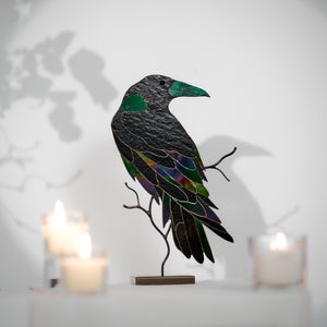 Handcrafted stained glass raven sculpture with metal branch base for table decor