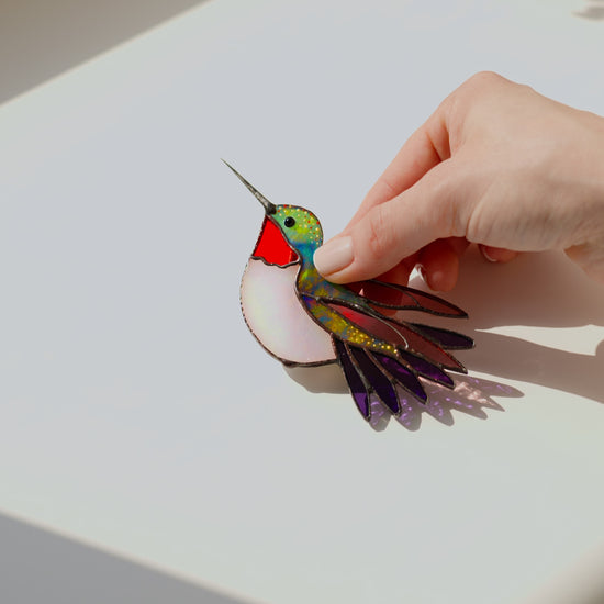 Ruby-throated hummingbird stained glass clip decor attached to a plant