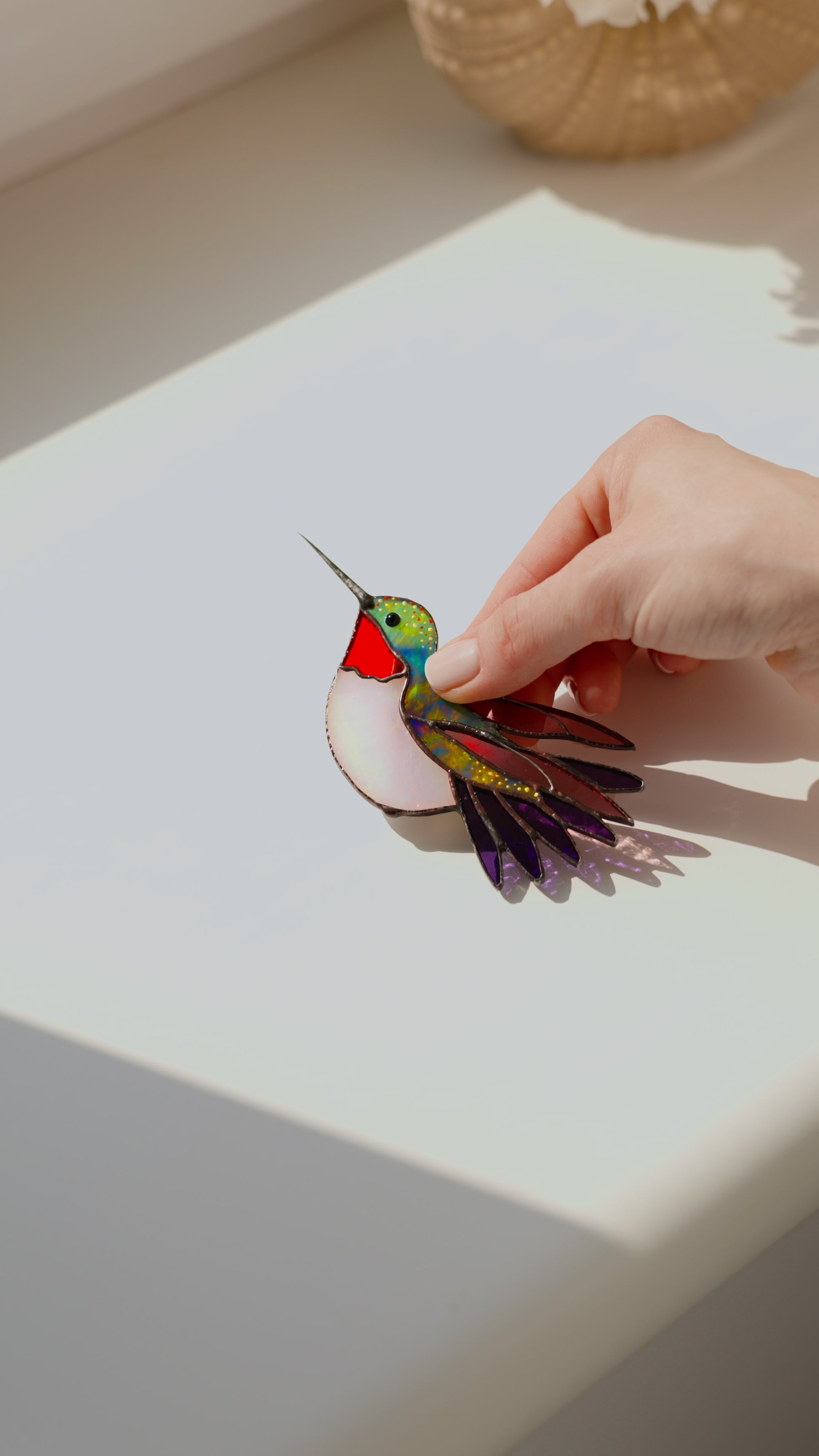 Ruby-throated hummingbird stained glass clip decor attached to a plant